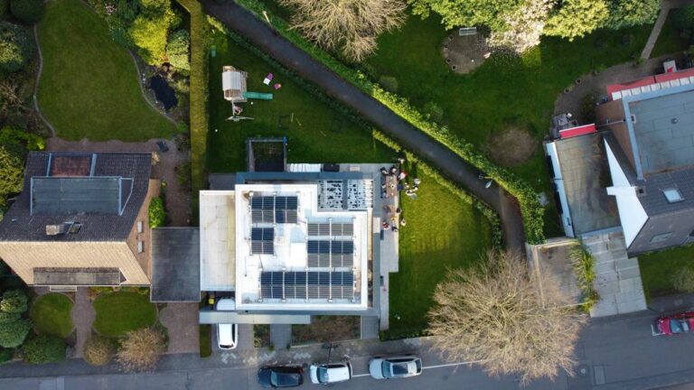 Aerial view of houses with solar panels on their rooftops