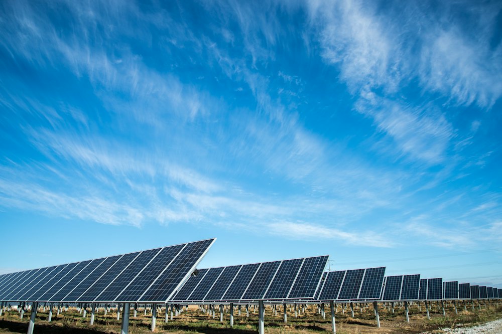 Standalone solar panel set against a bright blue sky