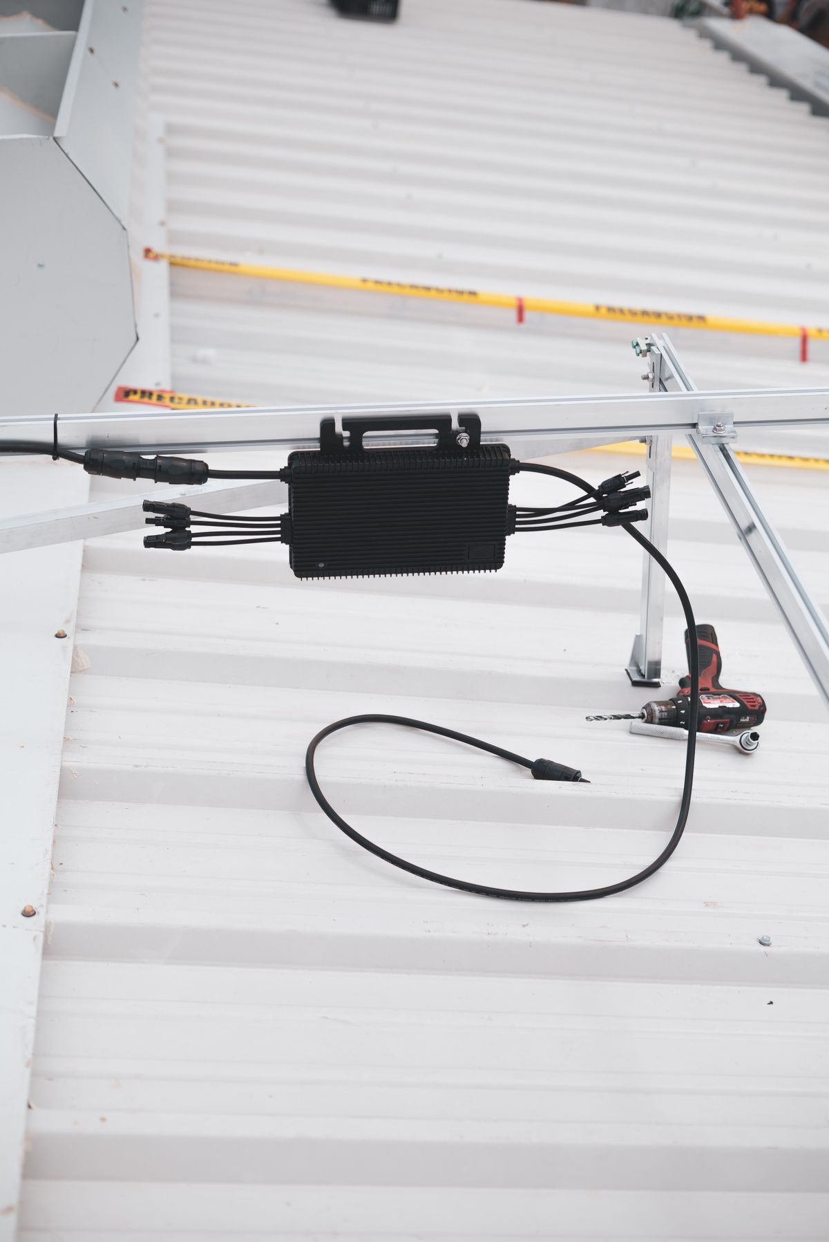 Close-up of a solar charge controller and cabling on a metal roof