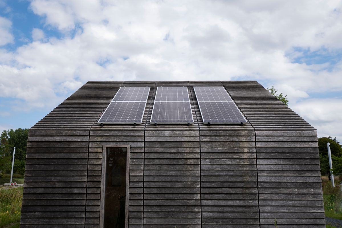 Wooden house with solar panels on its roof